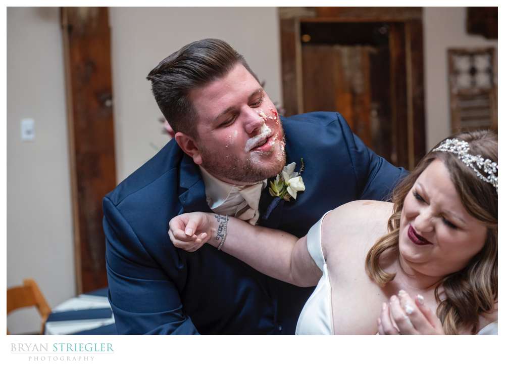 groom trying to kiss bride